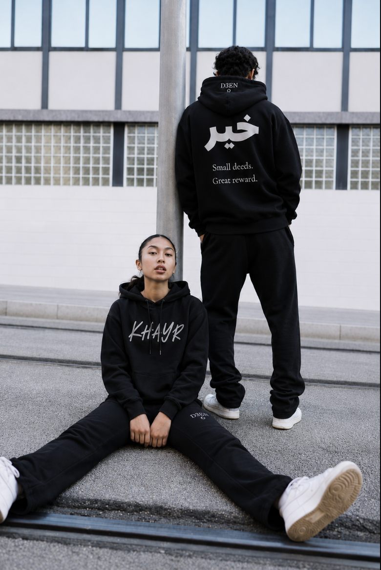Two models wearing the D3EN Khayr hoodie and matching trackpants in black