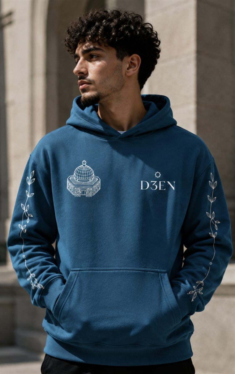 Front of the Until Freedom hoodie in deep teal, with the Dome of the Rock and the D3EN mark on the chest